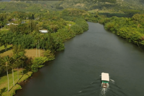 a boat traveling along a river.