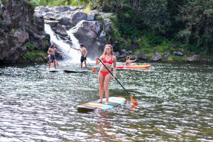 a group of people rowing a boat in the water