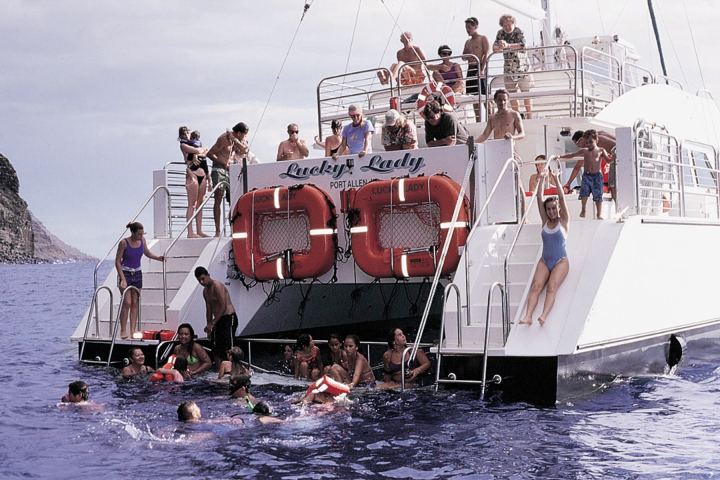 a group of people in a boat on a body of water