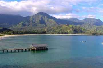 a large body of water with a mountain in the background