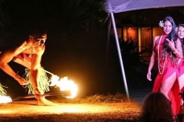 a woman standing in front of a fire