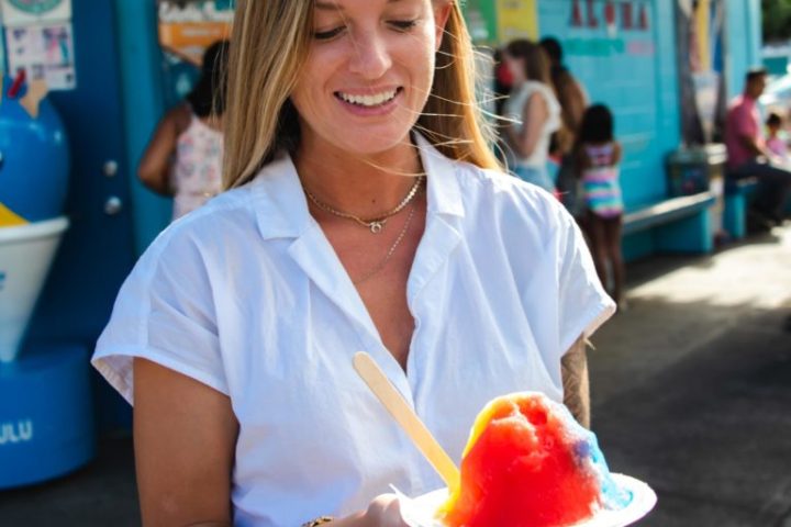 a woman holding a hot dog