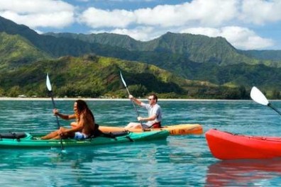 a group of people in a small boat in a body of water