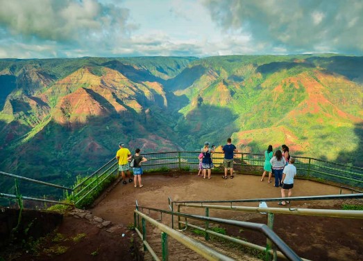 a group of people standing on top of a mountain