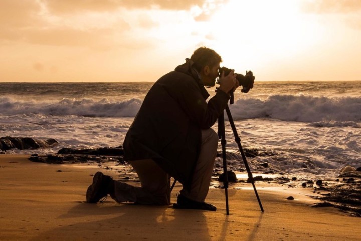 a man standing on top of a sandy beach