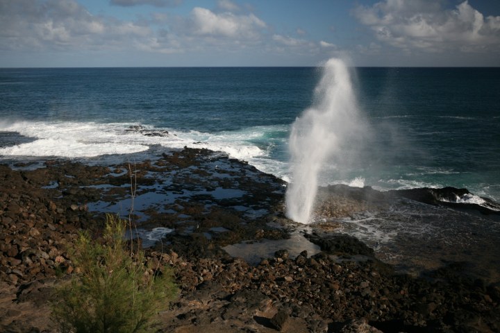 a body of water with smoke coming out of the ocean