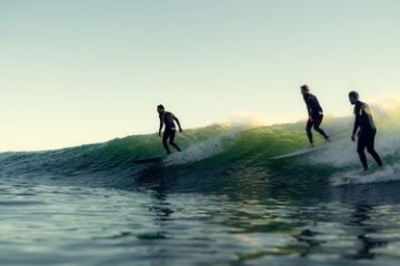 a man riding a wave on a surfboard in the ocean