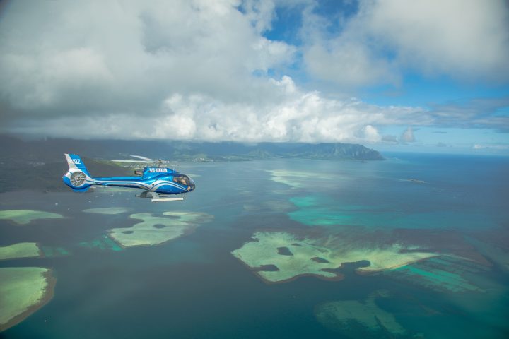 a helicopterflying over a body of water