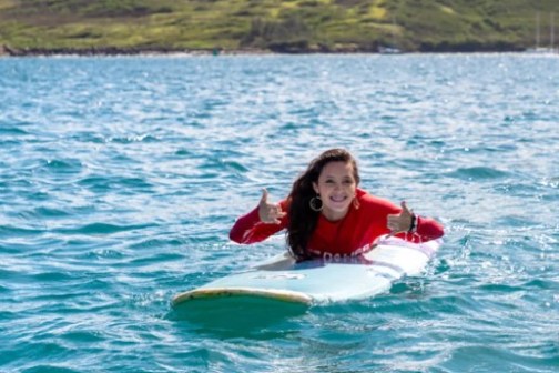 a person riding a surf board on a body of water